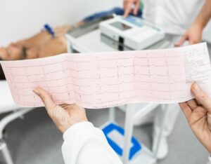 Cardiogram,Test,,Close-up,Of,Ecg,Report,Over,Mature,Male,Patient